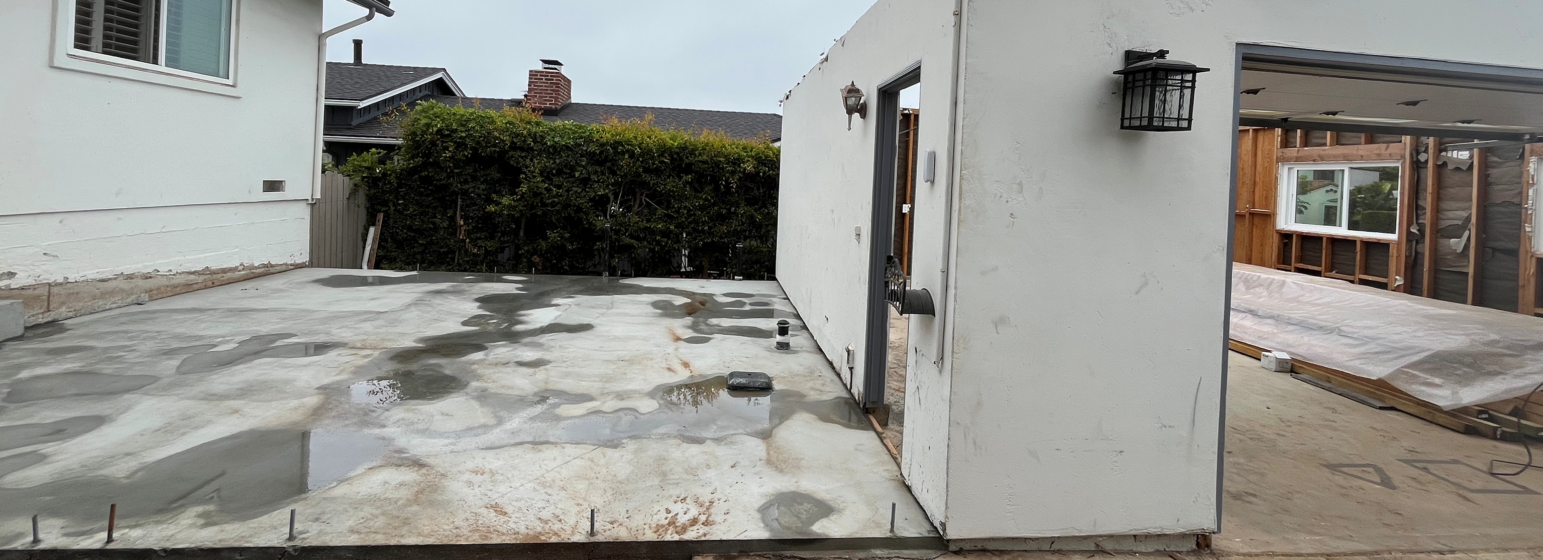 Concrete slab between house and detached garage during addition construction