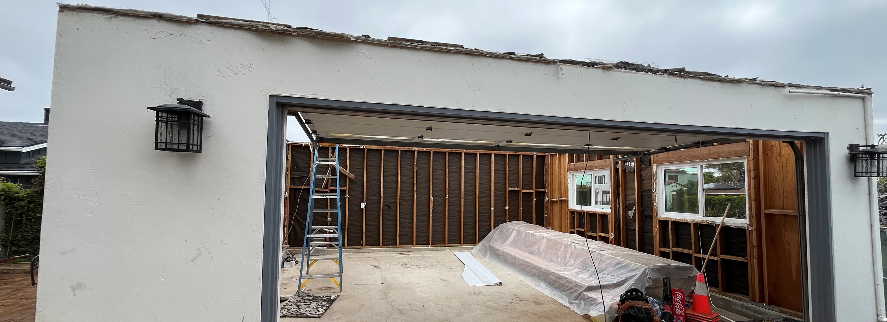 Exposed wall framing inside detached garage during recreation room conversion