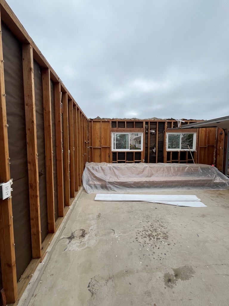 Exposed garage window wall framing during recreation room conversion