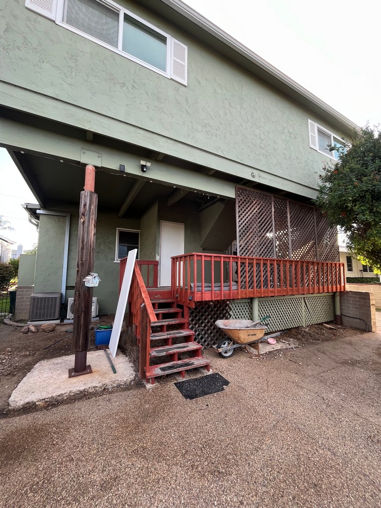 Full exterior view of existing deck and addition area prior to renovation and expansion work.