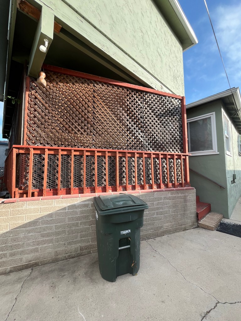 Side view of existing deck with lattice privacy screening and aging railing system.