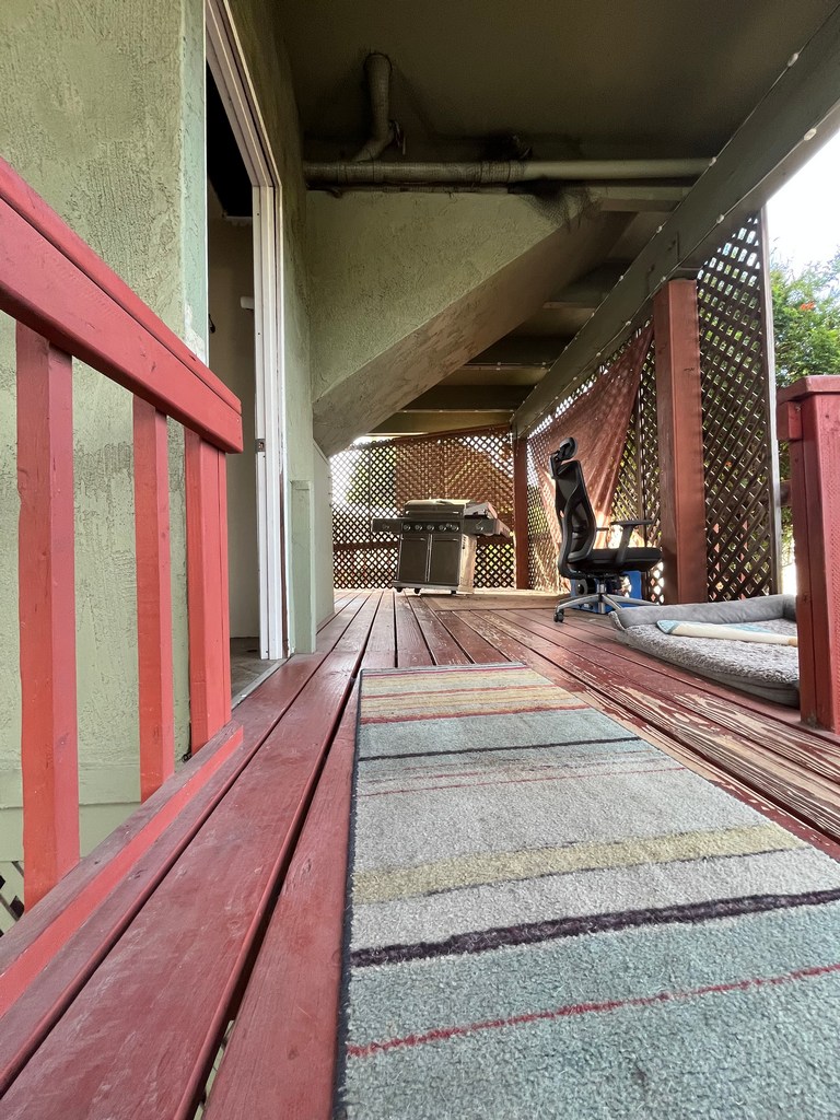 Existing deck surface showing weathered boards and aging finish prior to remodel.