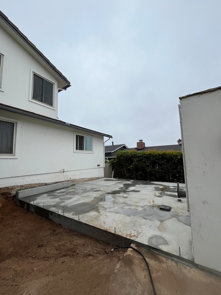 Newly poured connector slab between existing house and detached garage