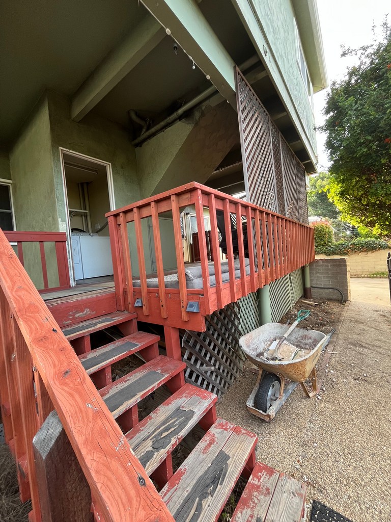 Existing deck stair access leading to laundry room entry prior to addition improvements.