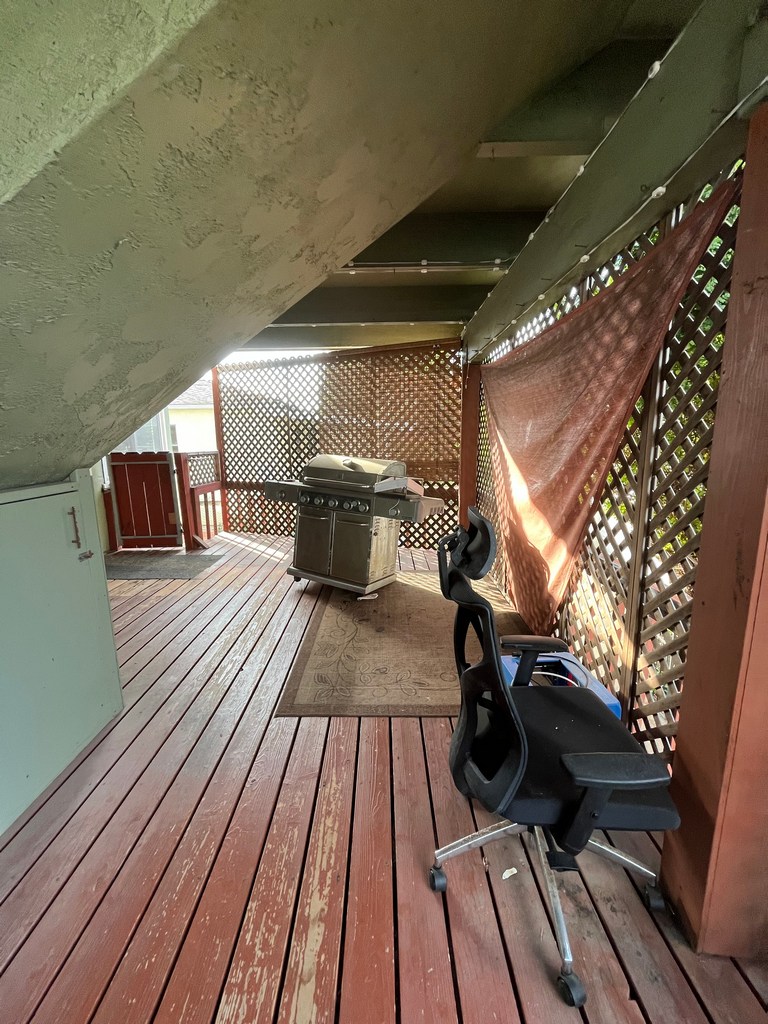 Under-deck structural area showing stair framing and limited clearance before remodel.