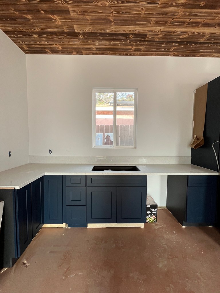 Kitchen cabinets with quartz countertop.