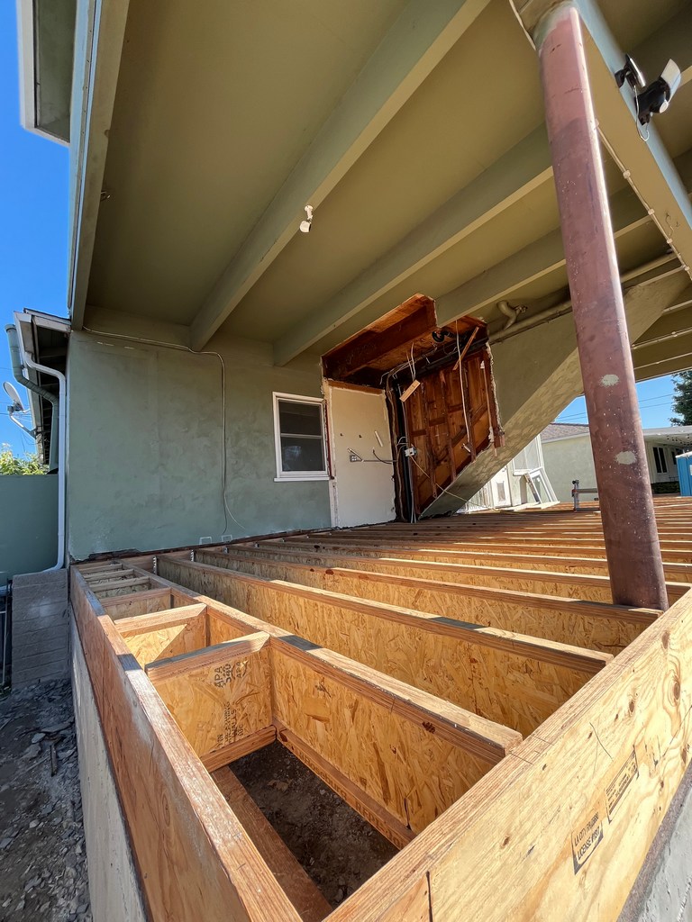 Structural layout of floor joists showing spacing, alignment, and load distribution for addition.