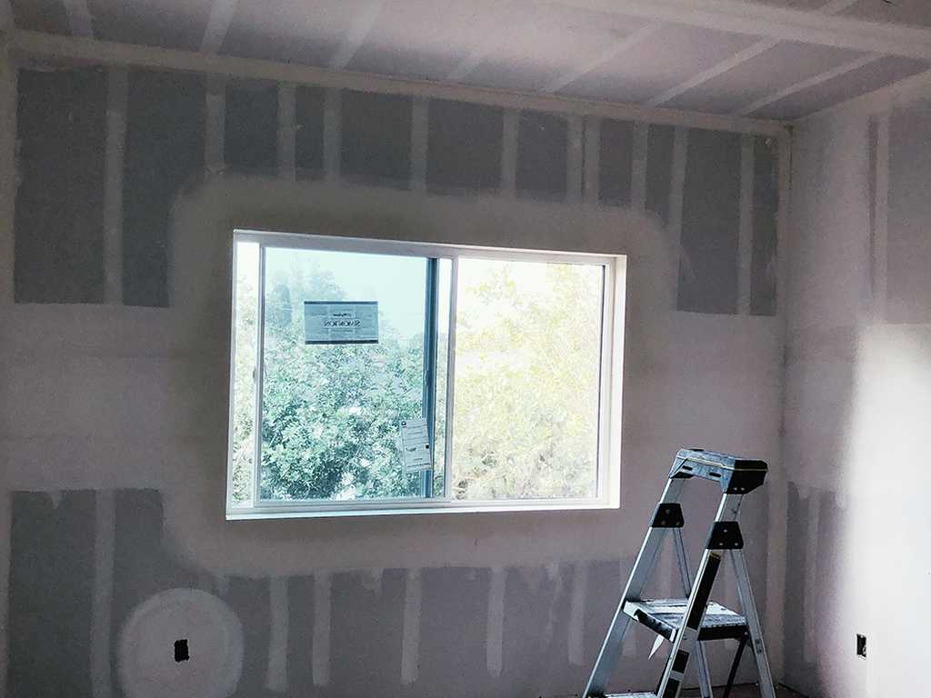 window-area-showing-newly-installed-drywall-with-paper-tape-and-mud-applied