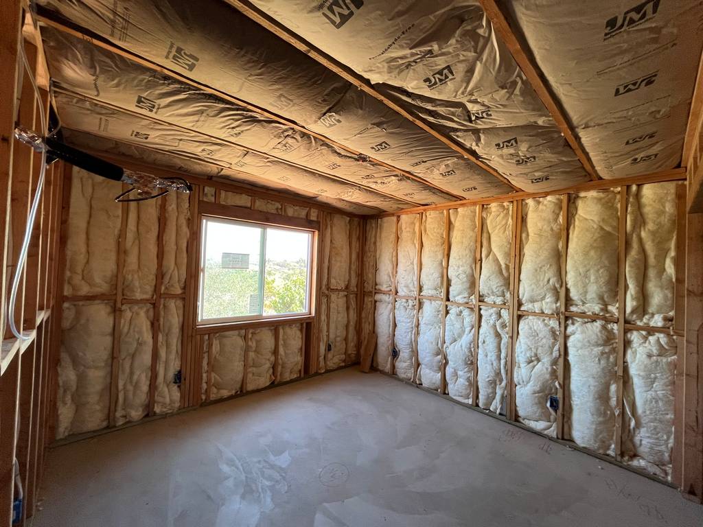 Enhance indoor climate control using JM insulation between roofing trusses.