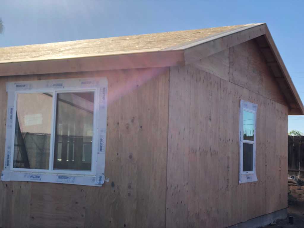 ADU showing the sheeted roof, wood siding and vinyl windows