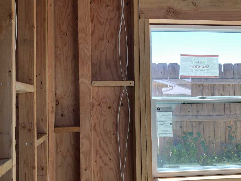 ADU showing wood studs frame and vinyl window