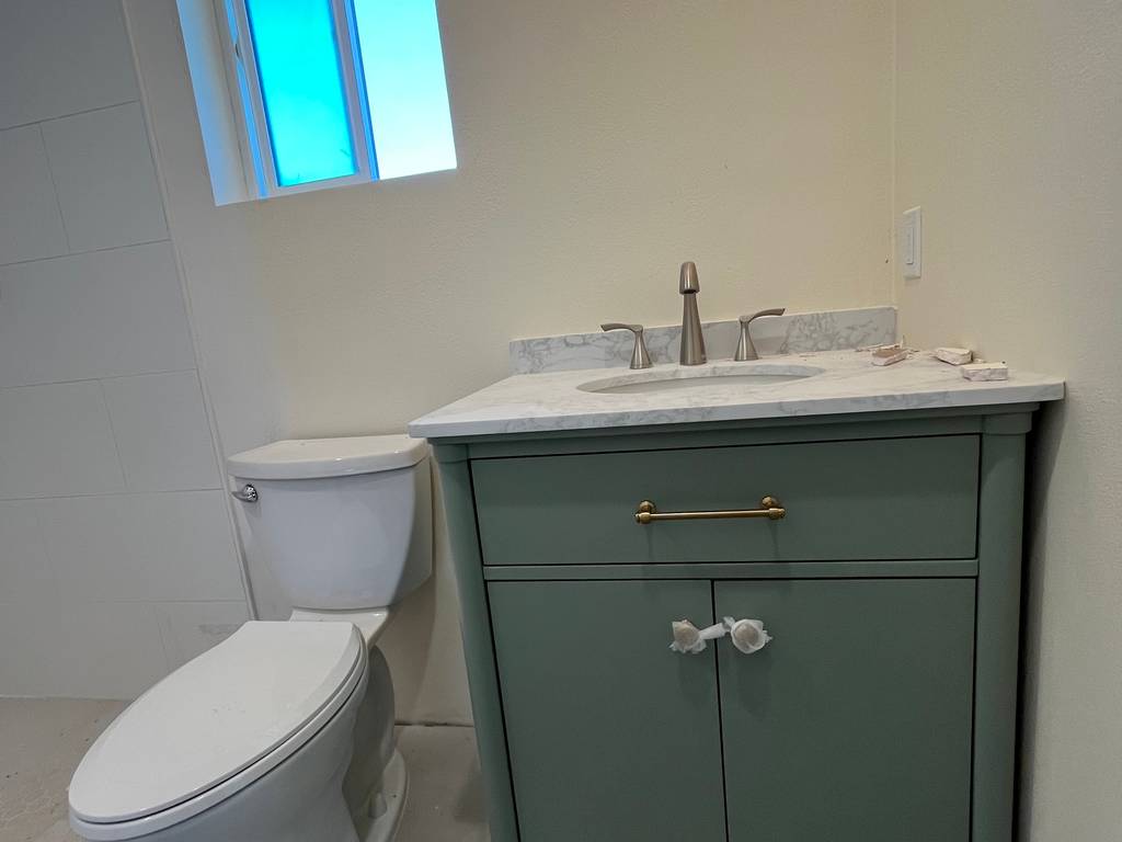 custom made vanity marble sink brass fixtures jade finish walk in shower large tiles H2Optimum toilet