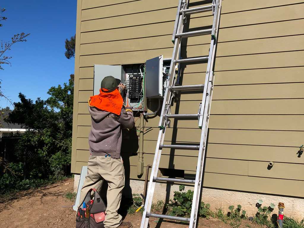 Electrician installing the power panel with a2mContractors
