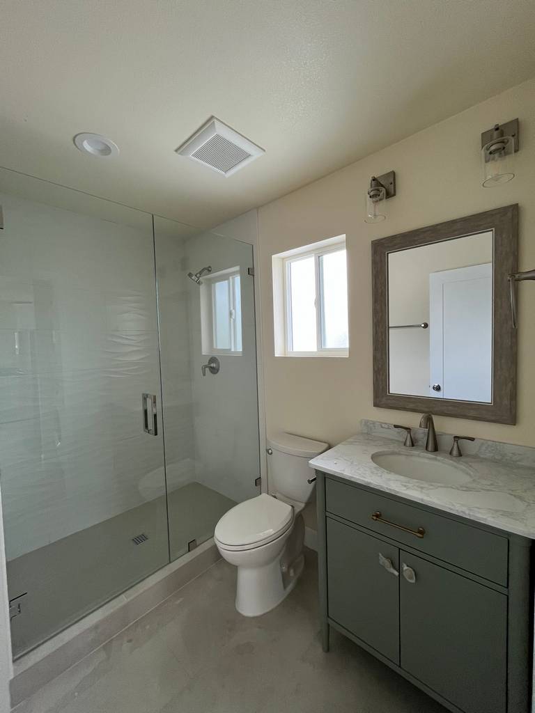 Elegantly designed bathroom with glass shower adding a touch of sophistication.