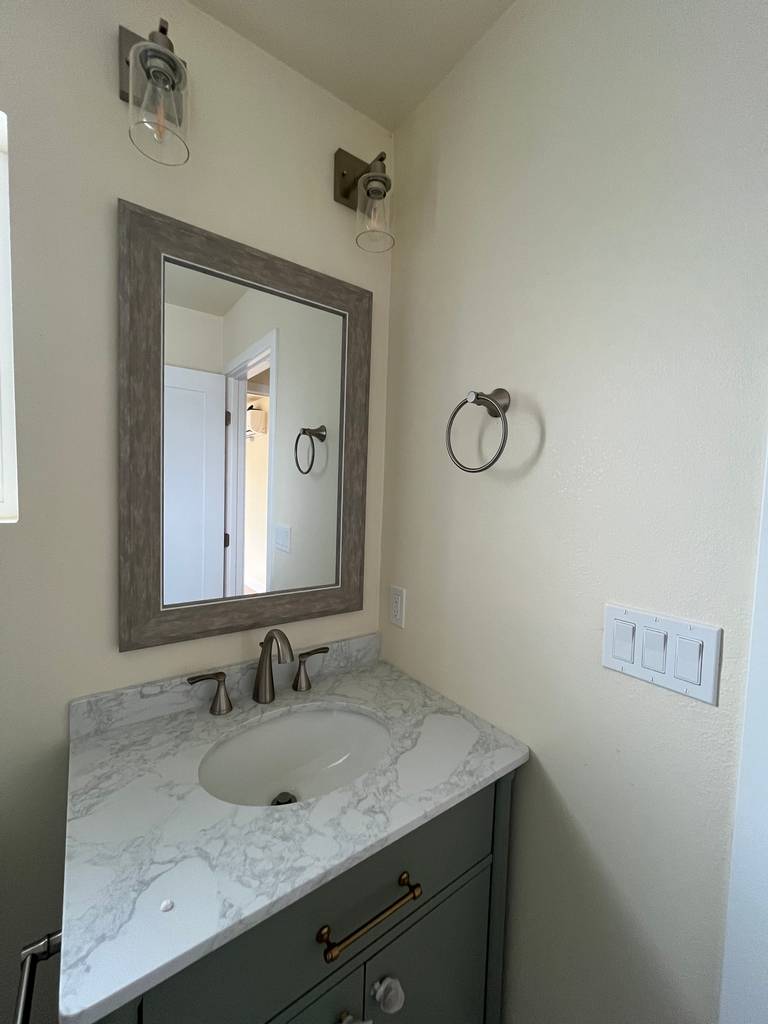 Beautifully designed vanity with white marble countertop in the 2nd Story ADU's bathroom.