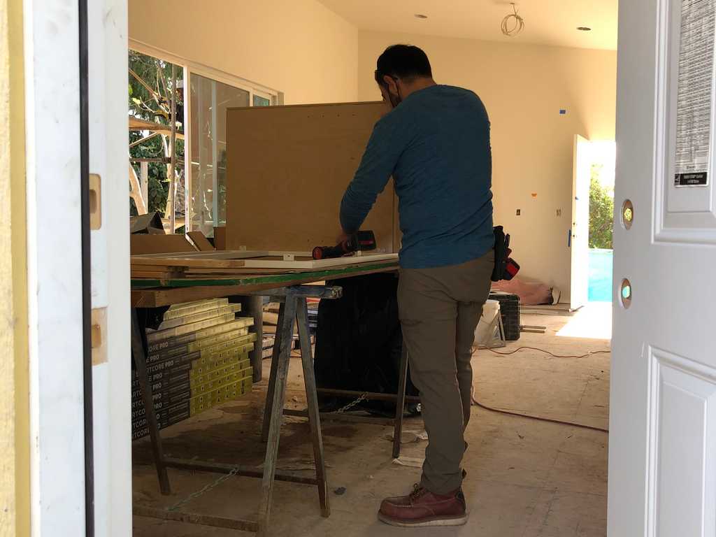 professional carpenter at a2mContractors building custom cabinets