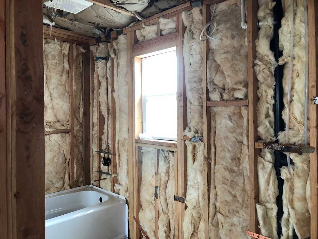 ADU showing wood framing, fibergalss insulation and bathroom tub