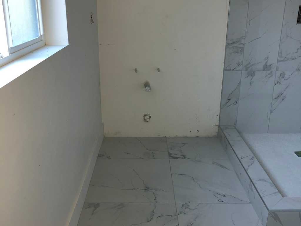 ADU showing new bathroom's marble floor