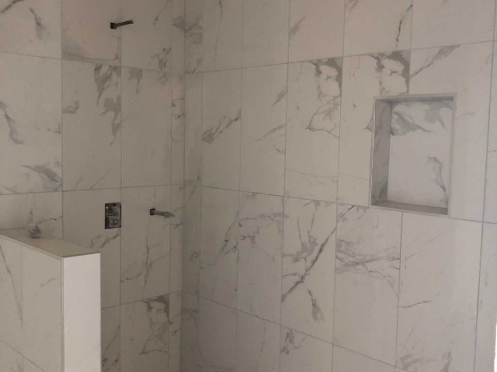 ADU showing new walk-in shower with marble tile