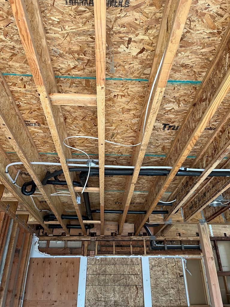 plumbing drainage lines, vent pipes, and electrical connections
