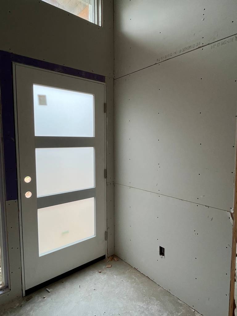 Professional drywall installation near entrance