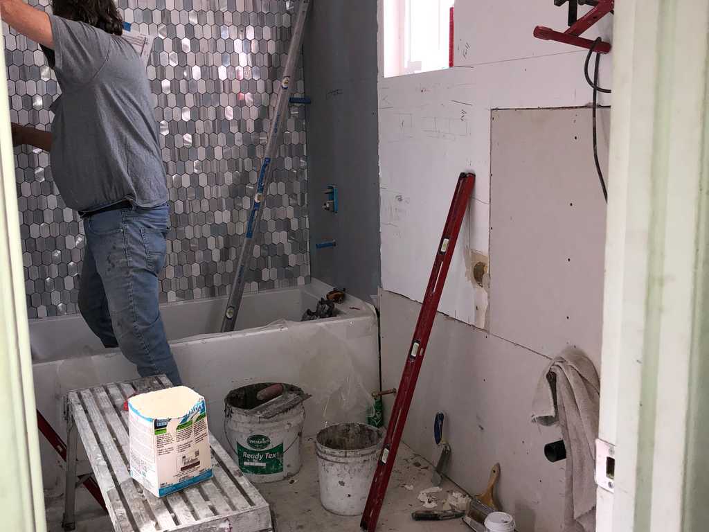 grouting tile wall in new bathroom
