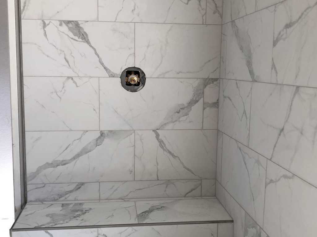 bathroom remodel A2M Contractors setting shower tiles