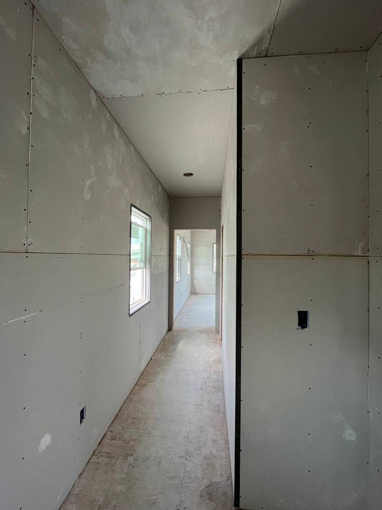 drywall on the walls and ceiling on the hallway entrance in the home addition