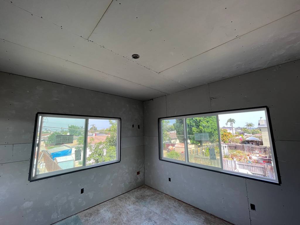 sheetrock on the walls and ceiling of the home addition