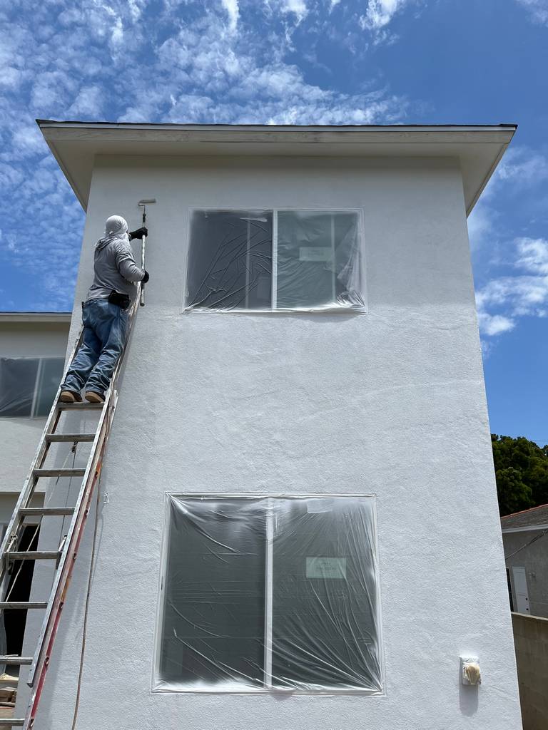applying final coat over the exterior walls