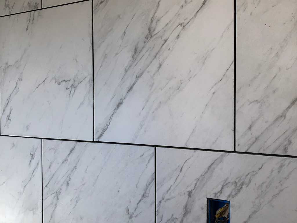 marble tile showing plastic spacing wedges