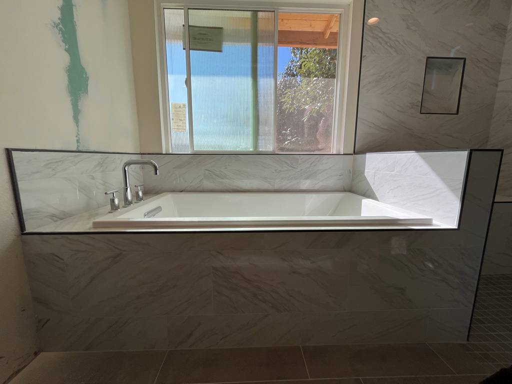 Custom designed bathtub with marble walls