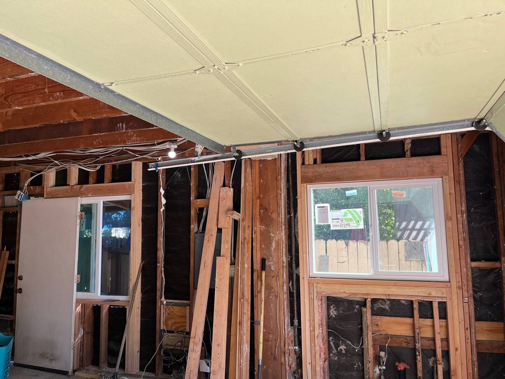 Garage Conversion: Exposed Structural Frame and Utility Connections