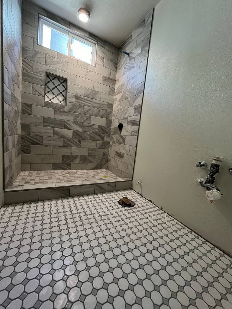 Bathroom remodel with a walk-in shower and beautiful tile floor