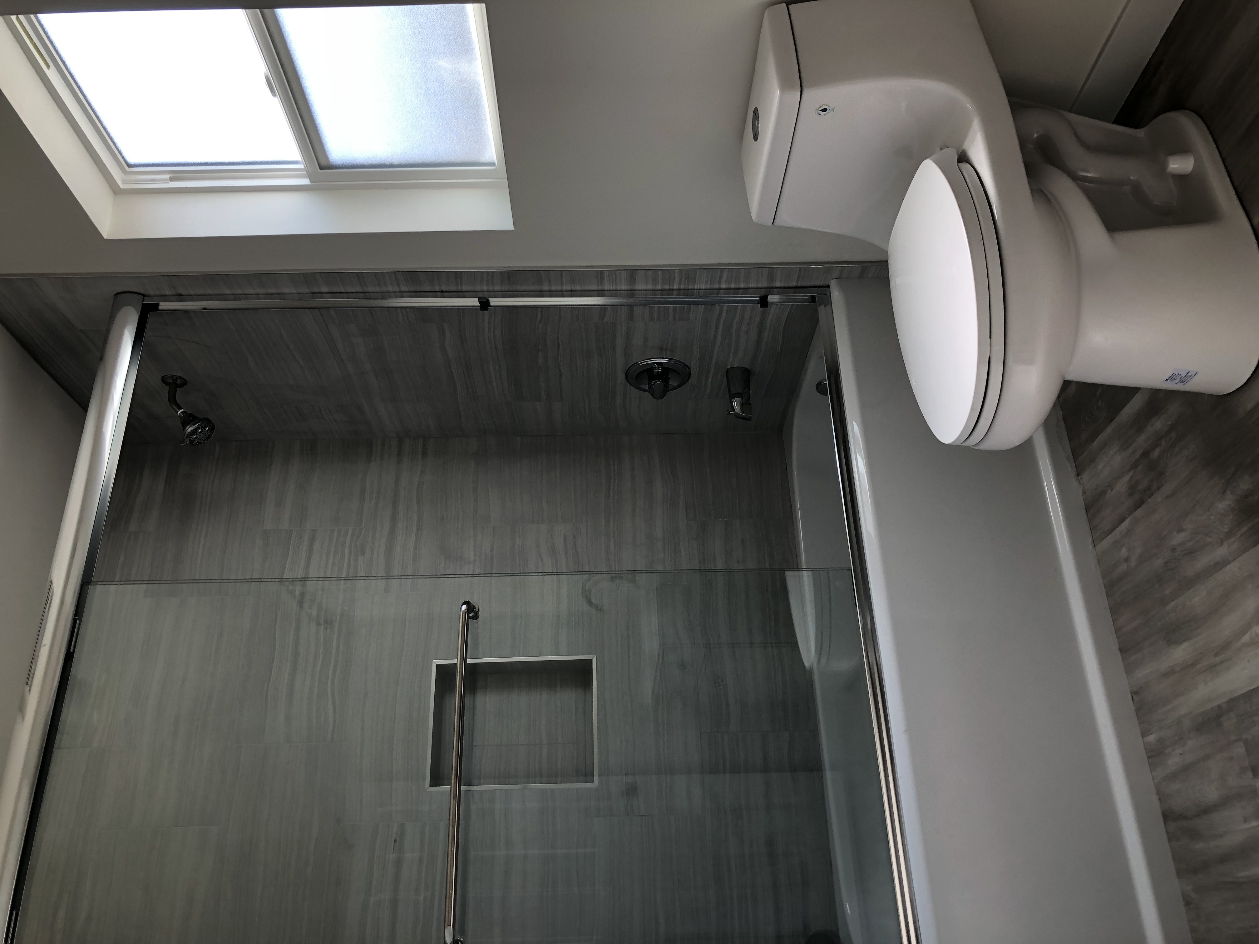 newly-built-ADU-showing-custom-cabinet-and-beautiful-light-fixture-in-the-bathroom