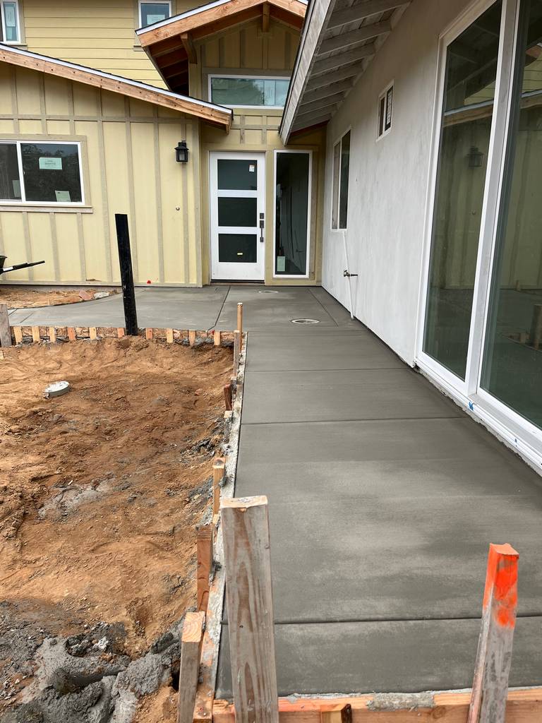newly pored concrete sideway to the backyard entrance of the pation