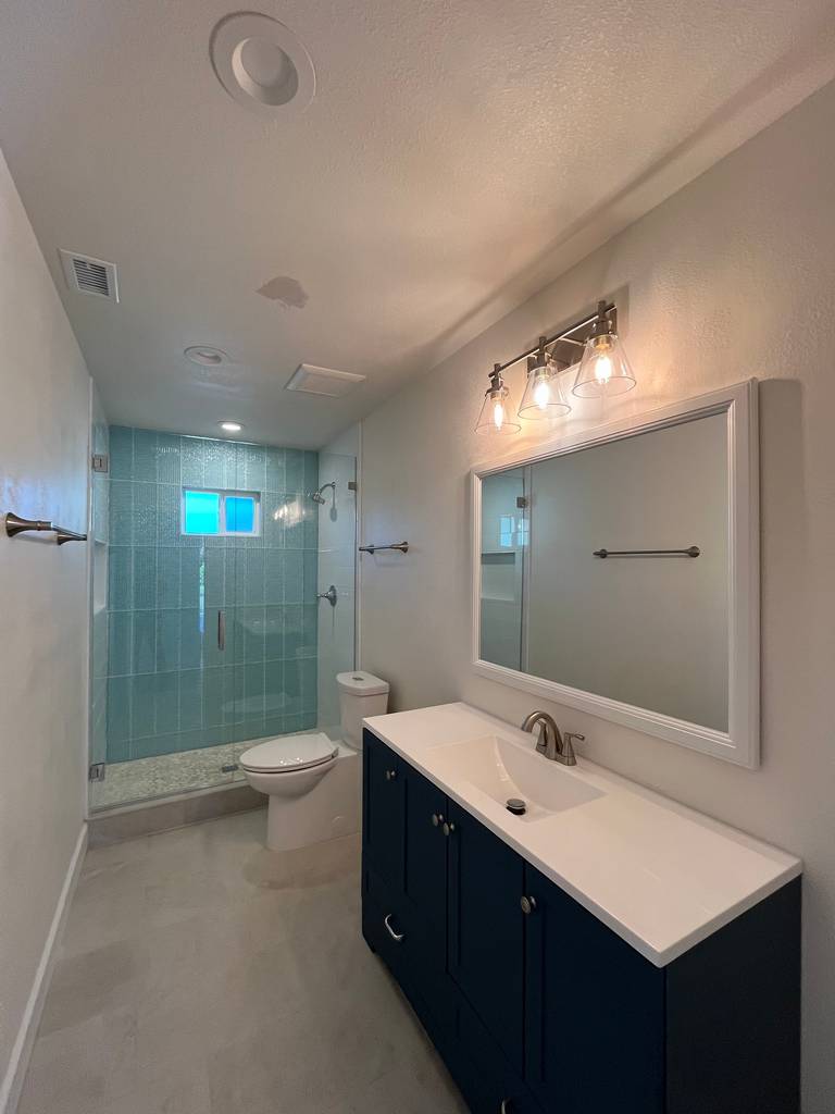 Walk in shower with beautiful light ocean blue tile in this home edition