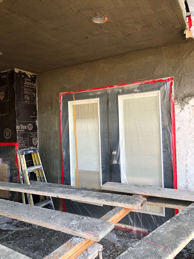 stucco-applied-around-double-french-door-frame-on-home-addition