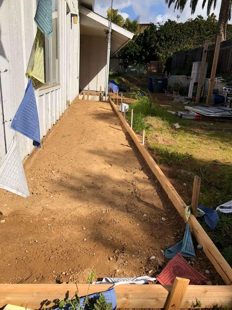 compating the ground for new sidewalk