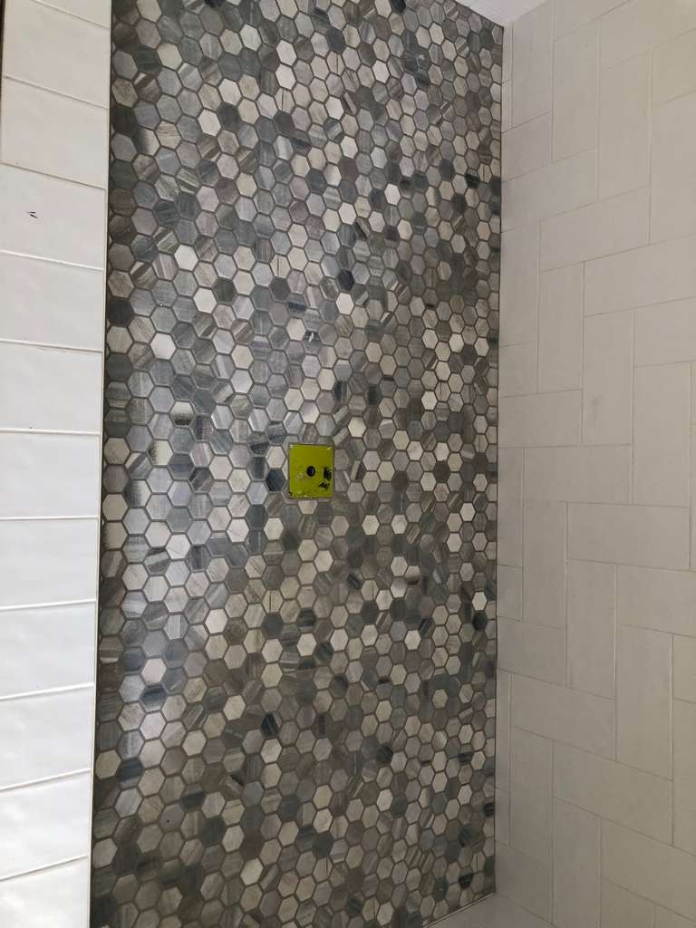 new shower with mosacic tile