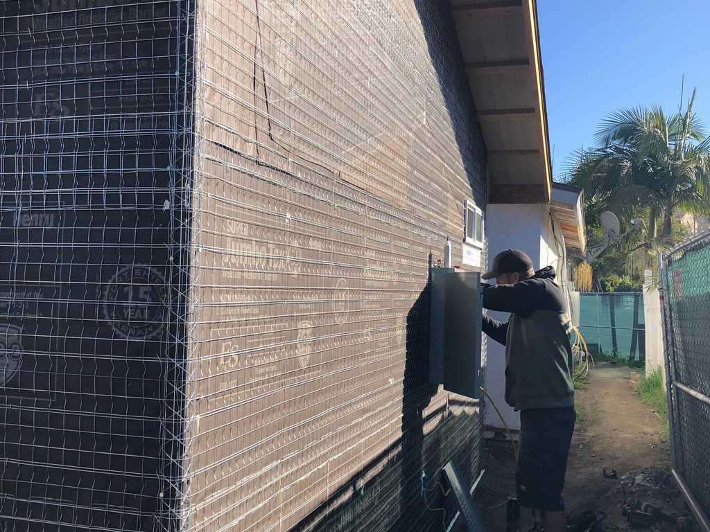 ADU applying paper and lath to siding