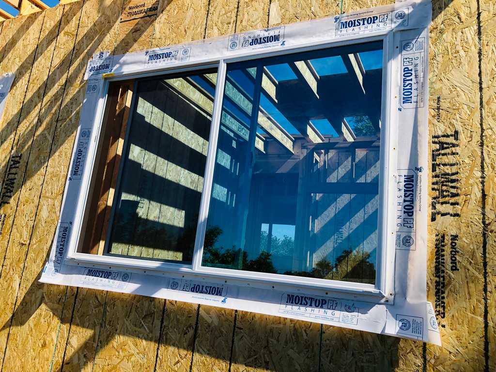 ADU installed vinyl window over moisture control flashing