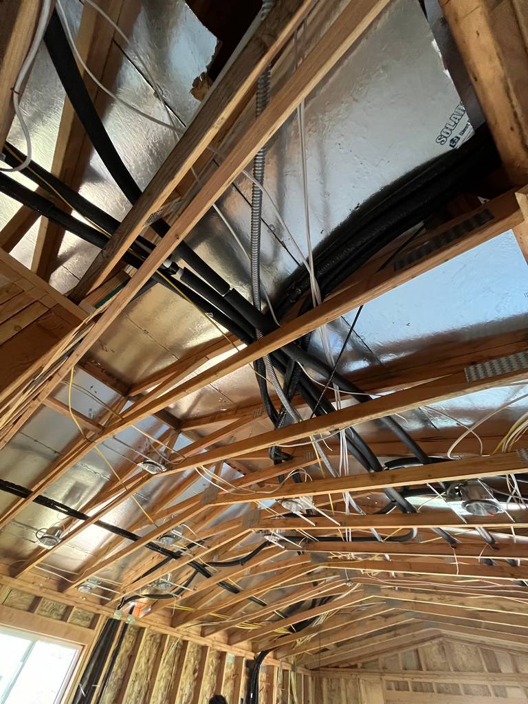 electrical pipe and wire network through roof truss