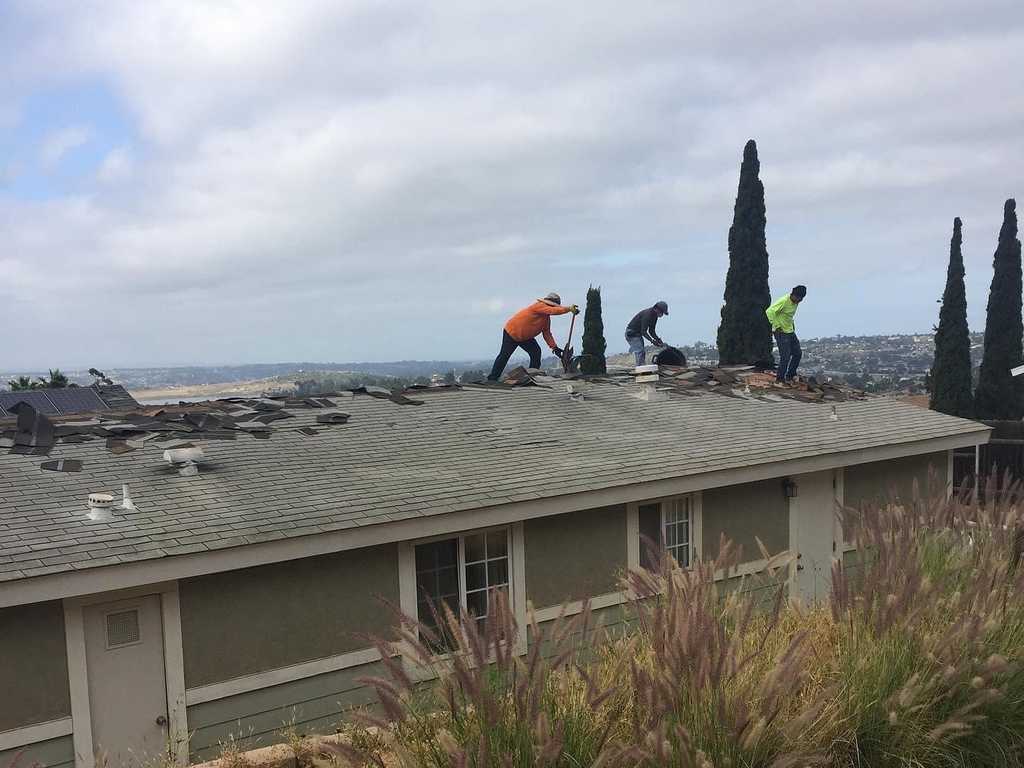 a2mcontractors workers removing shingle roof