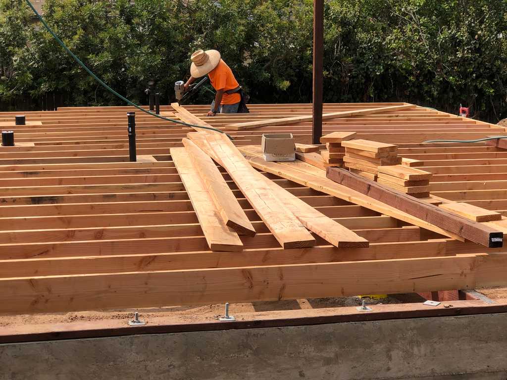 a2mContractors fasteninng the floor joist to foundation_34