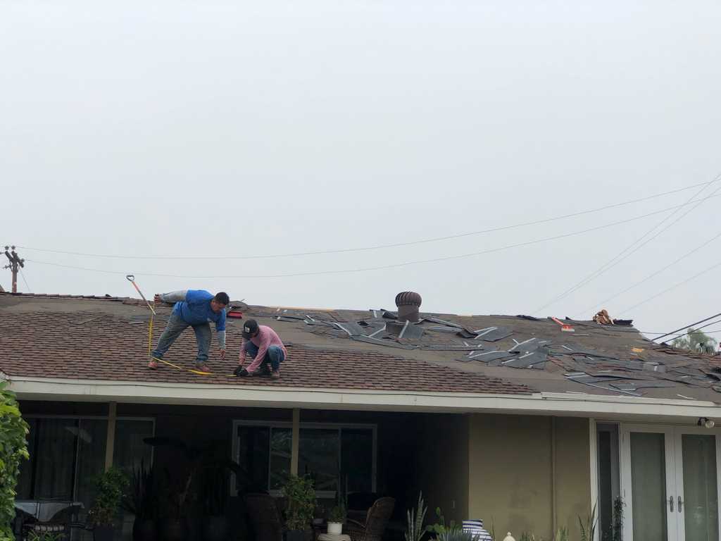 a2mContractors laying out a shingle roof