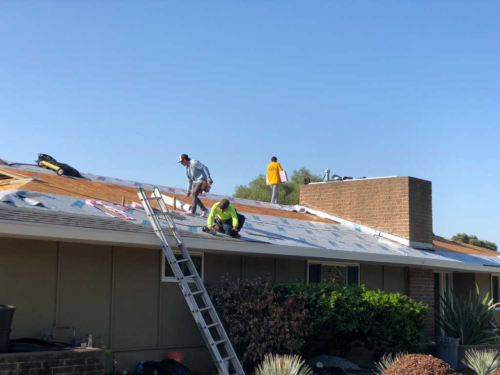a2mContractors roofing workers laying down roof protection