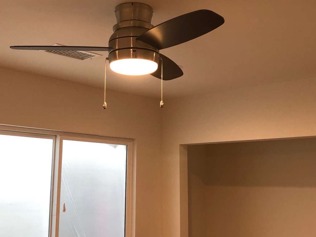 3 bladed ceiling fan with the light on