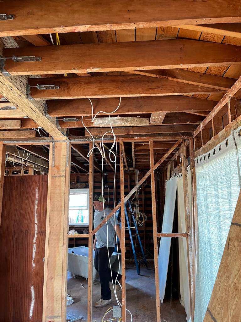 Framing with exposed ceiling beams and electrical wiring. (11)