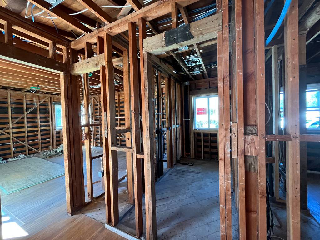 Interior framing exposed with electrical wiring visible